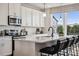 Modern kitchen with stainless steel appliances, white cabinetry, and an island with bar seating at 3128 Stelfox St, Charlotte, NC 28262