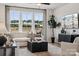 Bright living room featuring a comfortable sectional sofa, modern decor, and large windows at 3128 Stelfox St, Charlotte, NC 28262