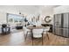Open living space features dining area adjacent to living room and modern kitchen at 3128 Stelfox St, Charlotte, NC 28262