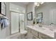 Modern bathroom features a glass-enclosed shower and a vanity with a stylish mirror at 3132 Stelfox St, Charlotte, NC 28262