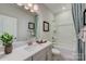 Bathroom featuring a single sink vanity, mirror, framed art, and a shower-tub combo at 3132 Stelfox St, Charlotte, NC 28262