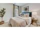 Well-lit bedroom with decorative lamps, a comfortable bed, side tables, and natural light at 3132 Stelfox St, Charlotte, NC 28262