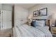 Cozy bedroom showcasing decorative pillows, framed art, side tables, and a closet at 3132 Stelfox St, Charlotte, NC 28262