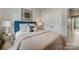 Bright bedroom featuring a cozy bed, decorative pillows, lamps, and a closet at 3132 Stelfox St, Charlotte, NC 28262