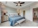 Comfortable main bedroom features a tray ceiling, coordinated furnishings, and a walk in closet at 3132 Stelfox St, Charlotte, NC 28262
