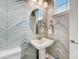 Chic powder room features stylish blue and white patterned walls and a pedestal sink at 3132 Stelfox St, Charlotte, NC 28262