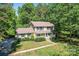 An aerial view of the home showcasing its well-maintained lawn, inviting front porch, and lush surroundings at 335 Bob White Run, Salisbury, NC 28147