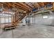 Unfinished basement featuring exposed beams, stairs, and a concrete foundation ready for customization at 335 Bob White Run, Salisbury, NC 28147