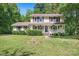 Two-story house with a welcoming front porch, American flag, and landscaped front yard at 335 Bob White Run, Salisbury, NC 28147