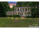 Charming two-story home with a manicured lawn, a welcoming front porch, and classic shutters at 335 Bob White Run, Salisbury, NC 28147