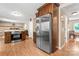 An open kitchen featuring stainless steel appliances, dark wood cabinetry, and a stone accent wall at 335 Bob White Run, Salisbury, NC 28147