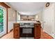 Kitchen island with granite counters, stainless steel appliances, and a view to the living area at 335 Bob White Run, Salisbury, NC 28147