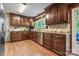 A gourmet kitchen featuring stainless steel appliances, granite countertops, and dark wood cabinetry at 335 Bob White Run, Salisbury, NC 28147