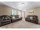 Cozy living room with plush seating, neutral walls, and views out of the front windows at 335 Bob White Run, Salisbury, NC 28147