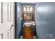 Stylish powder room with a vessel sink, decorative mirror, and navy blue walls at 335 Bob White Run, Salisbury, NC 28147