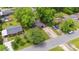 Aerial view of a charming home with a long driveway and lush, mature trees surrounding the property at 3828 Delgany Dr, Charlotte, NC 28215