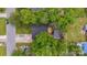 A bird's-eye view of a house with a backyard deck, mature trees, and a convenient carport at 3828 Delgany Dr, Charlotte, NC 28215