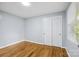 Bright bedroom features hardwood floors, light gray walls, and natural light from a window at 3828 Delgany Dr, Charlotte, NC 28215