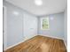 Bright bedroom features hardwood floors, light gray walls, and natural light from a window at 3828 Delgany Dr, Charlotte, NC 28215