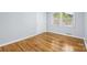 Bright bedroom features hardwood floors, light gray walls, and natural light from a window at 3828 Delgany Dr, Charlotte, NC 28215