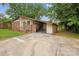 Driveway view of a single-story home featuring a brick facade and an attached carport at 3828 Delgany Dr, Charlotte, NC 28215