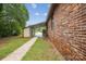 Brick home exterior featuring a carport, a small window and a side yard at 3828 Delgany Dr, Charlotte, NC 28215
