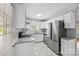 Modern kitchen boasts stainless steel appliances, granite countertops, and white cabinets at 3828 Delgany Dr, Charlotte, NC 28215