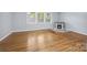 Bright living room features hardwood floors, a decorative fireplace, and natural light at 3828 Delgany Dr, Charlotte, NC 28215