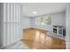 Inviting living room with gleaming hardwood floors, a decorative fireplace, and bright windows at 3828 Delgany Dr, Charlotte, NC 28215