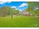 Expansive backyard featuring a well-manicured lawn, wooden deck, and screened-in porch at 3864 Meadow Ridge Nw Dr, Concord, NC 28027