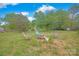 Backyard featuring mature trees, a fire pit, and multiple chairs at 3864 Meadow Ridge Nw Dr, Concord, NC 28027