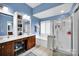 Spacious bathroom boasts a double vanity, a soaking tub under window shutters, and a glass-enclosed shower at 3864 Meadow Ridge Nw Dr, Concord, NC 28027