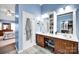 Bright bathroom with double vanity, neutral tile, and a doorway leading to a bedroom at 3864 Meadow Ridge Nw Dr, Concord, NC 28027