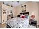 Nautical-themed bedroom with a large bed, mirrored closet, and decorative shelf at 3864 Meadow Ridge Nw Dr, Concord, NC 28027