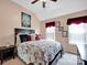 Cozy bedroom featuring nautical decor, including a sailboat painting and framed pictures by the window at 3864 Meadow Ridge Nw Dr, Concord, NC 28027