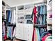 Well-organized walk-in closet with ample hanging space, shelving, and drawers for efficient storage at 3864 Meadow Ridge Nw Dr, Concord, NC 28027