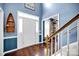 Welcoming foyer featuring hardwood floors, wainscoting, front door with sidelights, and a staircase at 3864 Meadow Ridge Nw Dr, Concord, NC 28027