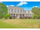 Beautiful two-story home with a manicured lawn, black shutters, and a welcoming front porch at 3864 Meadow Ridge Nw Dr, Concord, NC 28027