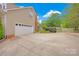 Spacious detached garage with ample parking, a large driveway, and well-maintained landscaping at 3864 Meadow Ridge Nw Dr, Concord, NC 28027