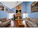 Cozy living room with a stone fireplace, vaulted ceiling, and hardwood floors at 3864 Meadow Ridge Nw Dr, Concord, NC 28027