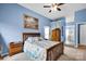 Comfortable bedroom with a ceiling fan, complemented by stylish decor and an attached bathroom at 3864 Meadow Ridge Nw Dr, Concord, NC 28027