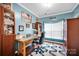 Bright office with wooden desk, chair, and rug complemented by a decorative 'dream' sign and artwork at 3864 Meadow Ridge Nw Dr, Concord, NC 28027