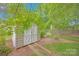 Storage shed in the backyard surrounded by mature trees and a wood fence at 3864 Meadow Ridge Nw Dr, Concord, NC 28027