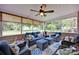 Inviting sunroom with wicker furniture, ceiling fan, and view of the landscaped backyard at 3864 Meadow Ridge Nw Dr, Concord, NC 28027