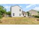 Exterior shot of a white two-story home featuring a grassy backyard with a wood fence at 4002 Solomons Ct, Monroe, NC 28110