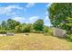 Large backyard featuring a fire pit, garden, shed, trees, and a wood fence at 4002 Solomons Ct, Monroe, NC 28110