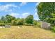 Large backyard featuring a fire pit, garden, shed, trees, and a wood fence at 4002 Solomons Ct, Monroe, NC 28110