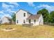 Spacious backyard featuring a fire pit, lawn, and a white two-story home in a suburban setting at 4002 Solomons Ct, Monroe, NC 28110
