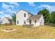 Spacious backyard featuring a fire pit, lawn, and a white two-story home in a suburban setting at 4002 Solomons Ct, Monroe, NC 28110