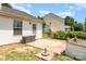 Patio area featuring a side door, storage box, and garden box with vinyl siding at 4002 Solomons Ct, Monroe, NC 28110